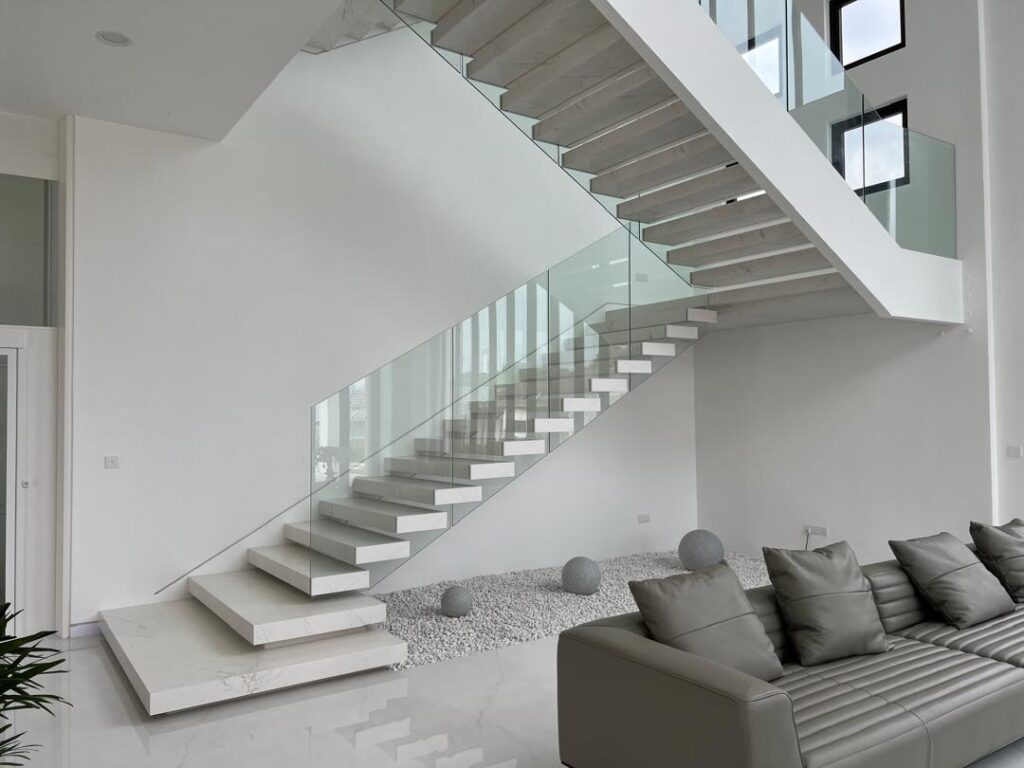 Modern floating marble staircase with glass railing